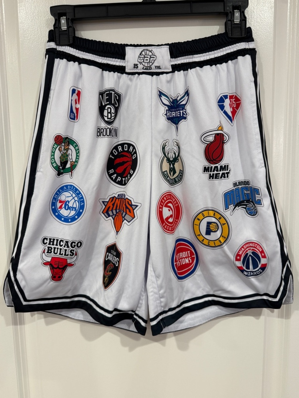 White Basketball Shorts with Black Trim and Team Patch Graphics